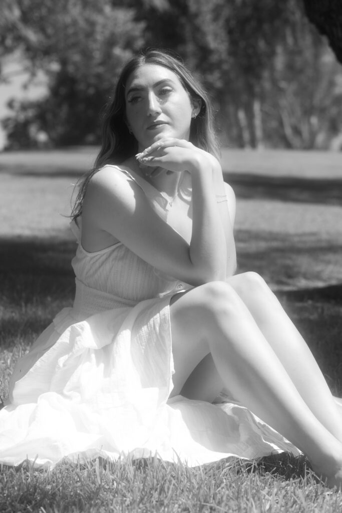 Black and White Photo of Woman Sitting on Grass Reflecting on Healing and Boundaries
